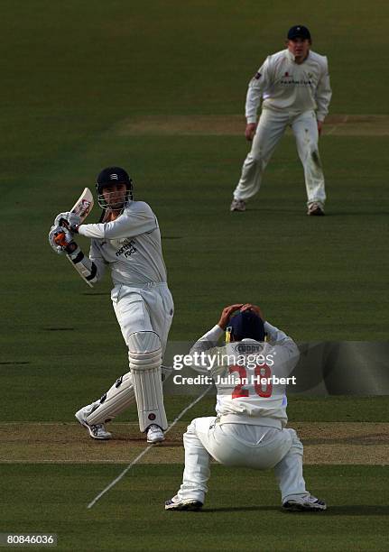 Middlesex batsman Tim Murtagh hits out as Gareth Rees of Gloustershire takes avoiding action during day two of the Liverpool and Victoria County...