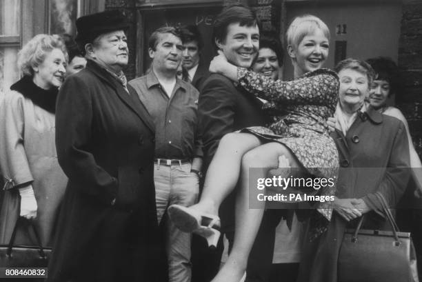 Coronation Street's Dennis Tanner , brings home his bride Jenny Sutton as other residents, including Ena Sharples look on.