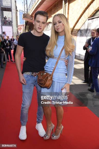 Jenny Elvers and her son Paul Jolig attend the Riani Fashion Show Spring/Summer 2018 at Umspannwerk Kreuzberg on July 4, 2017 in Berlin, Germany.