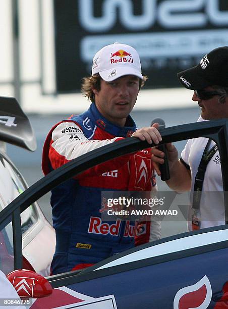 Four-time world champion Sebastien Loeb prepares to drive his car during the ceremonial start of the 2008 Jordan Rally in the Dead Sea on April 24,...