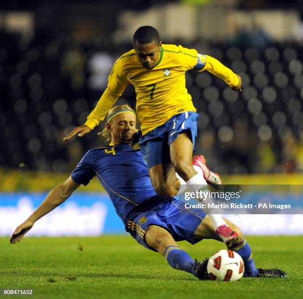 Brazil's Robinho jumps over a tackle from Ukraine's Anatoliy Tymoschuk