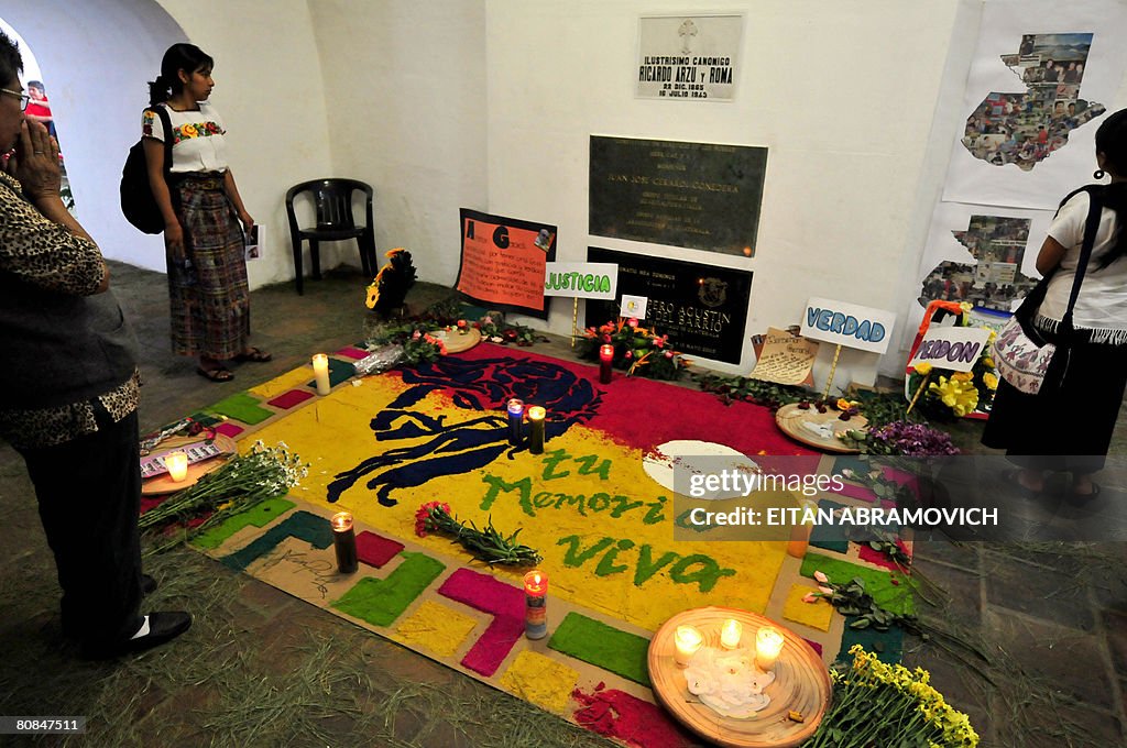 Women visit the crypt where Monsignor Ju