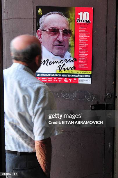 An man looks at the picture of Monsignor Juan Jose Gerardi at the entrance of the crypt where is buried in Guatemala's Metropolitan Cathedral on...