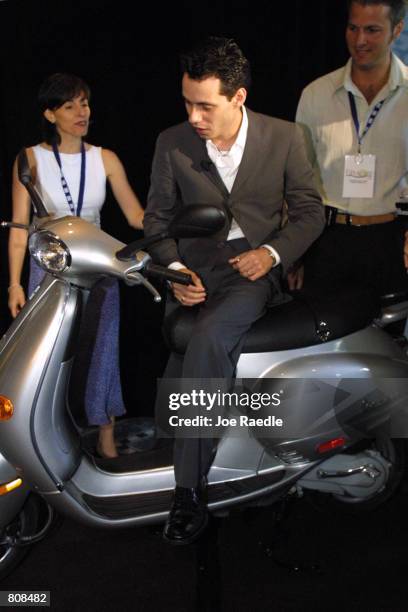 Singer Marc Anthony checks out a motor scooter given to him at the 12th Annual Billboard Latin Music Conference & Awards April 25, 2001 in Miami...