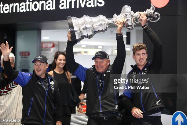 Glenn Ashby, Grant Dalton and Peter Burling of Team New Zealand arrive at Auckland International Airport with the Americas Cup Trophy on July 5, 2017...