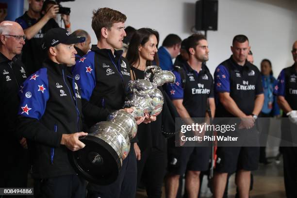 Glenn Ashby and Peter Burling of Team New Zealand arrive at Auckland International Airport with the America’s Cup on July 5, 2017 in Auckland, New...