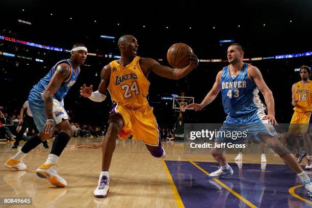 Kobe Bryant of the Los Angeles Lakers controls the ball against Carmelo Anthony and Linas Kleiza of the Denver Nuggets in Game Two of the Western...