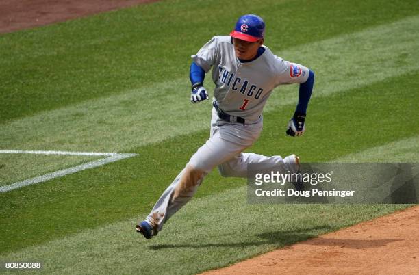 Kosuke Fukudome of the Chicago Cubs rounds third and heads home to score the Cubs first run on an RBI single by Felix Pie against the Colorado...