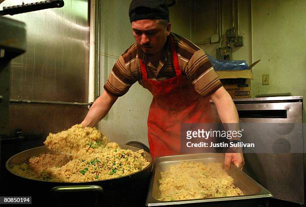 Prep cook Alex Alejandro prepares rice for the lunch buffet at Na'an and Curry Indian restaurant April 24, 2008 in San Francisco, California. As rice...