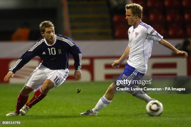 Scotland's Kris Commons and Faroe Island's Daniel Udsen in action during the International Friendly match at Pittodrie Stadium, Aberdeen.