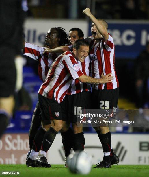 Brentford's Sam Wood is mobbed by Marcus Bean Charlie MacDonald and Gary Alexander after scoring the opening goal during the Carling Cup Fourth Round...