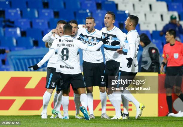 Ramiro of Gremio celebrates with teammates Pedro Rocha, Luan and Lucas Barrios after scoring the opening goal of his team during a first leg match...