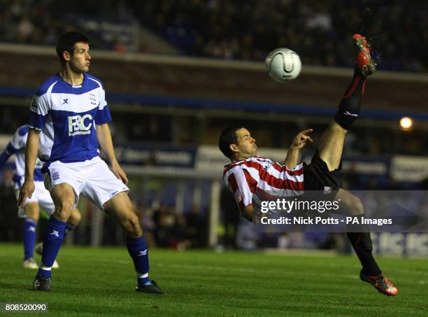 Brentford's Sam Wood shoots with an overheadkick past Birmingham City's Scott Dann during the Carling Cup Fourth Round match at St Andrew's,...