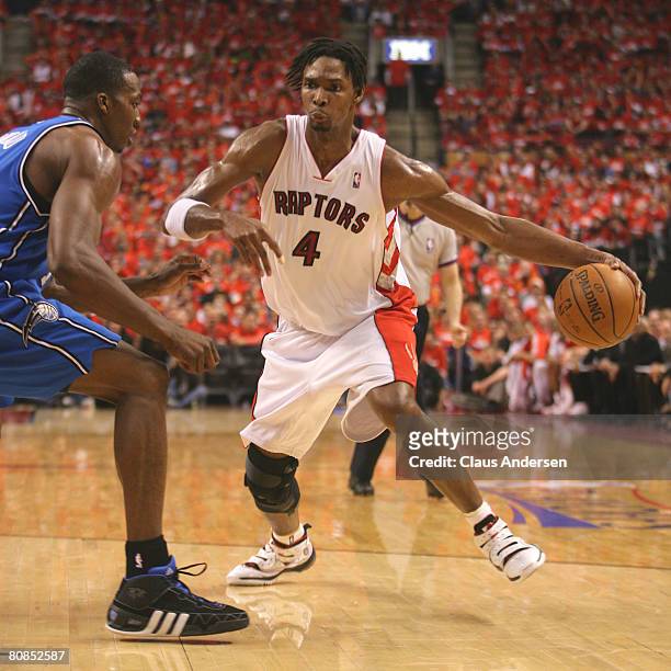 Chris Bosh of the Toronto Raptors goes around Dwight Howard of the Orlando Magic in game 3 of the Eastern Conference quarterfinals on April 24, 2008...