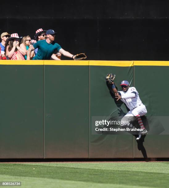 Center fielder Guillermo Heredia of the Seattle Mariners hits the wall after making a catch on a ball off the bat of Alex Gordon of the Kansas City...