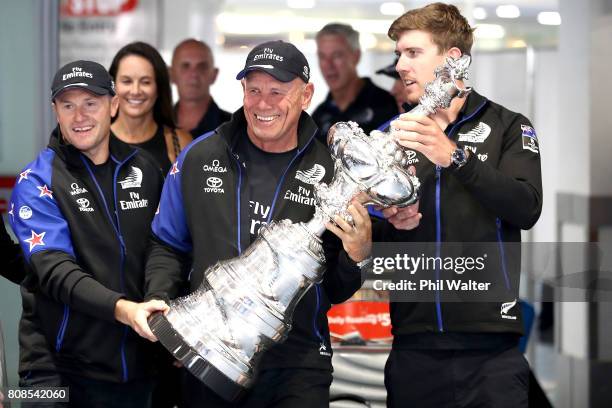 Glenn Ashby, Grant Dalton and Peter Burling of Team New Zealand arrive at Auckland International Airport with the America’s Cup on July 5, 2017 in...