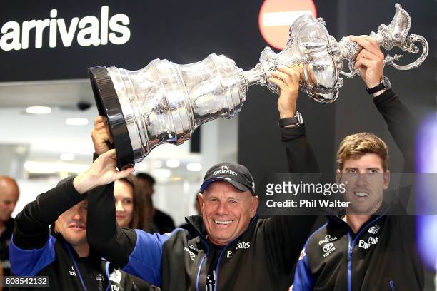Glenn Ashby, Grant Dalton and Peter Burling of Team New Zealand arrive at Auckland International Airport with the America’s Cup on July 5, 2017 in...