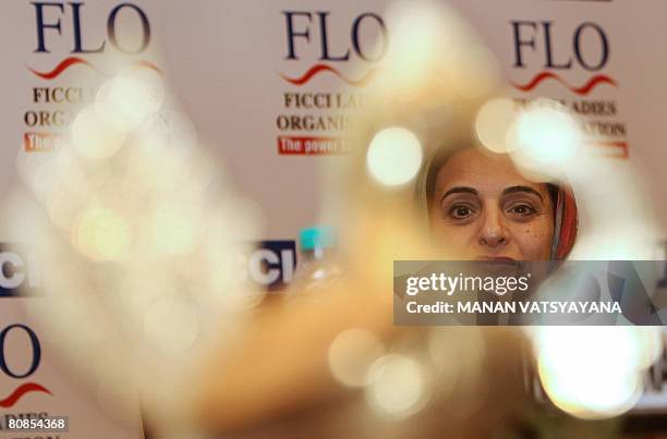 United Arab Emirates Minister of Foreign Trade, Sheikha Lubna Khalid Sultan Al Qasimi listens to an unseen speaker during a meeting with members of...