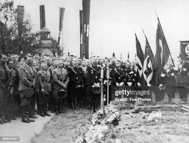 Nazi leader Adolf Hitler among the mourners at the funeral of his chauffeur Julius Schreck at Grafelfing near Munich, 20th May 1936. Also present is...