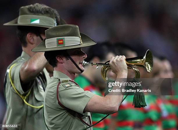 An Australian Soldier plays the Last Post in honour of Anzac Day before the round seven NRL match between the Brisbane Broncos and the South Sydney...