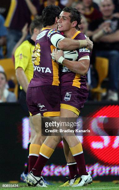 Denan Kemp of the Broncos celebrates with team mate Michael Ennis after scoring a try during the round seven NRL match between the Brisbane Broncos...