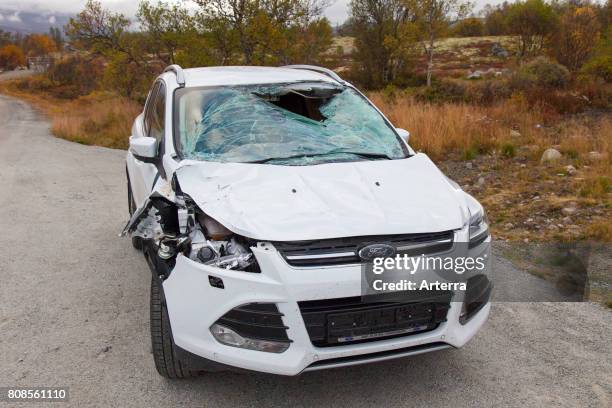 Wrecked car after collision with moose on road in Scandinavia.