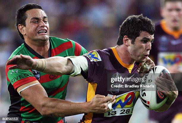 Michael Ennis of the Broncos attempts to break a tackle during the round seven NRL match between the Brisbane Broncos and the South Sydney Rabbitohs...