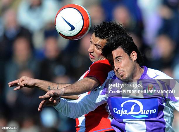 Atletico de Madrid's Spanish defender Pablo Ibanez Tebar heads the ball with Valladolid's Spanish defender Pedro Lopez during a Spanish league...