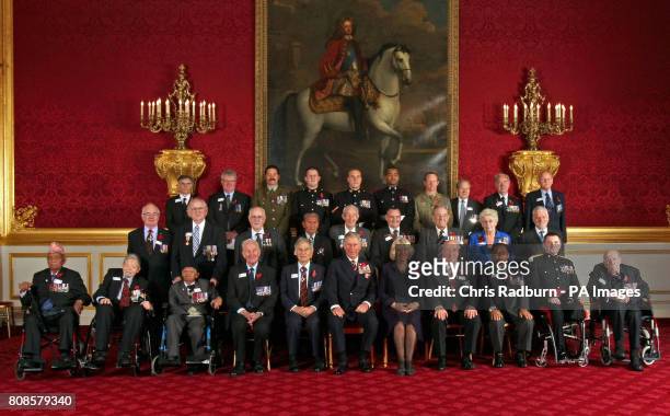 The Prince of Wales and the Duchess of Cornwall pose for an official photo with the Victoria Cross and George Cross Association at Clarence House...