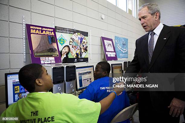 President George W. Bush shakes hands with a boy during a visit to the Northwest Boys & Girls Club on Malaria Awareness Day on April 25, 2008 in...