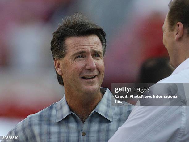 Tampa Bay Buccaneers general manager Bruce Allen talks with former player Trace Armstrong at Raymond James Stadium in a preseason game August 28,...