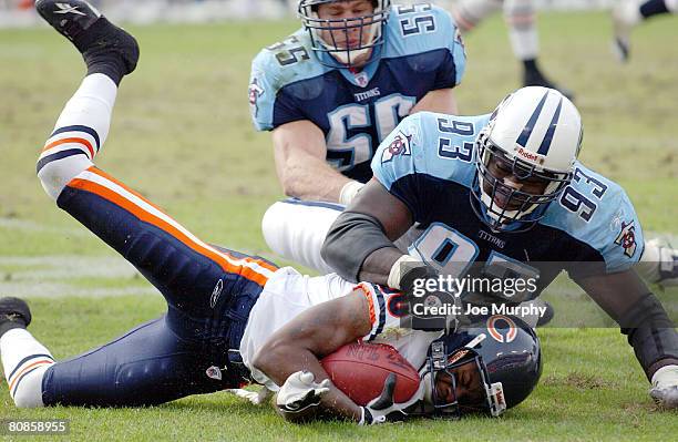 Bernard Berrian of the Chicago Bears is tackled by Kevin Carter of the Tennessee Titans. The Chicago Bears beat the Tennessee Titans 19-17 in...