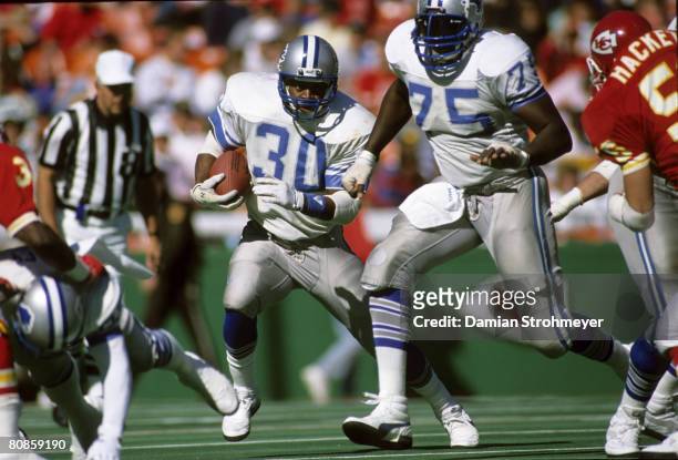Running back James Jones of the Detroit Lions carries the football behind the blocking of Lomas Brown during the Lions 7-6 victory over the Kansas...