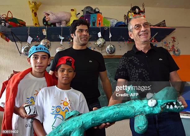 French businessman Michel Lacoste , CEO of Lacoste apparel company, holds a handicrafted cocrodile he received from students of the Gol de Letra...
