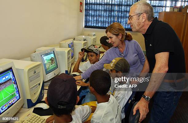 French businessman Michel Lacoste , CEO of Lacoste looks at children of the Gol de Letra social fundation playing games on computers during a visit...