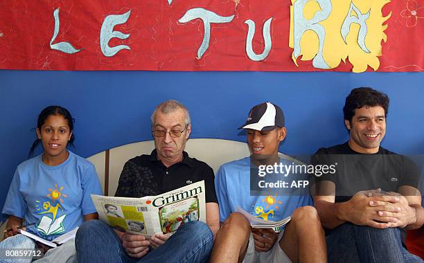 French businessman Michel Lacoste , CEO of Lacoste apparel company, and former Brazilian football star Rai sit amid children during a visit to Gol de...