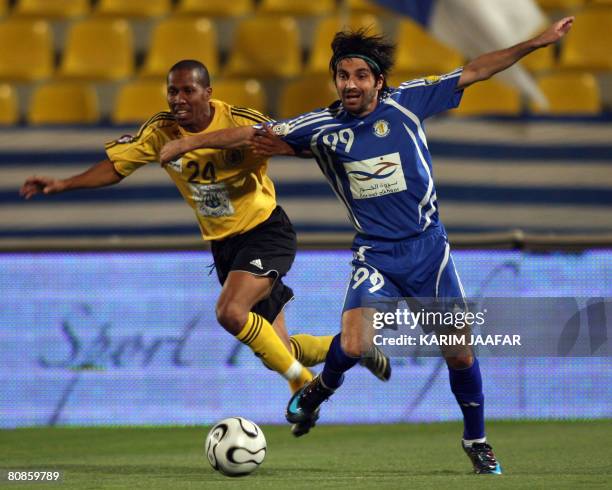 Qatar club's Ali Jumaah fights for the ball with Al-Khor's Iraqi player, Hawar Mulla Mohammed, during their Emir Cup football quarter-final match in...