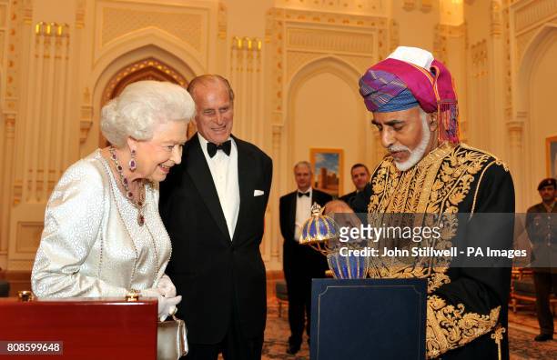Queen Elizabeth II is delighted as the Sultan of Oman, His Majesty Sultan Qaboos bin Said presents her with a gold musical Faberge style egg, before...