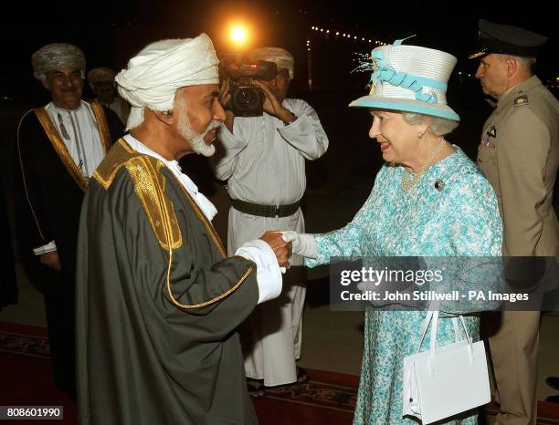 Queen Elizabeth II is greeted by the Sultan of Oman, His Majesty Sultan Qaboos bin Said, after arriving in Oman from the United Arab Emirates.