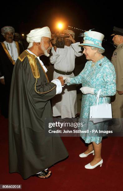 Queen Elizabeth II is greeted by the Sultan of Oman, His Majesty Sultan Qaboos bin Said, after arriving in Oman from the United Arab Emirates.