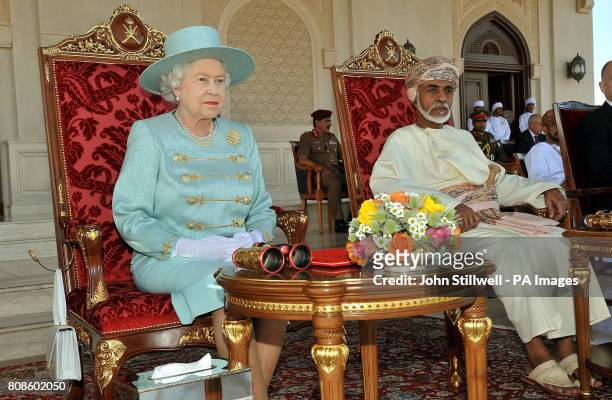 Britain's Queen Elizabeth II and the Sultan of Oman, His Majesty Sultan Qaboos bin Said, sit as they watch an equestrian event and horse racing, at...