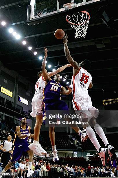 Errick Craven of the Los Angeles D-Fenders puts a shot up against Brent Petway and Roberto Bergersen of the Idaho Stampede during the second round of...