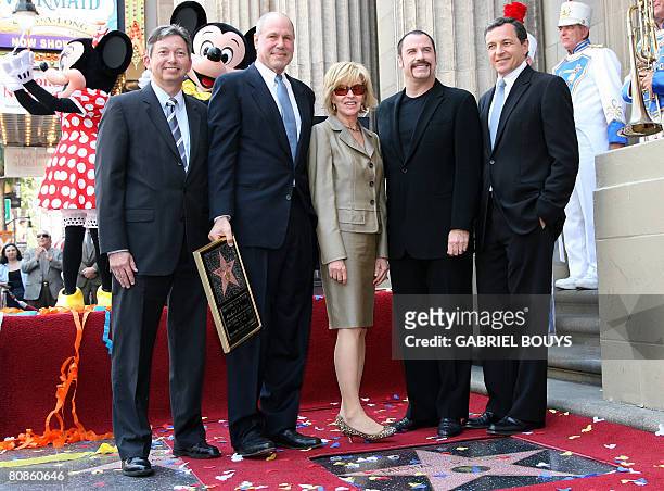 Movie mogul Michael D. Eisner poses with Hollywood chamber of commerce President Leron Gubler , his wife Jane Breckenridge, actor John Travolta and...