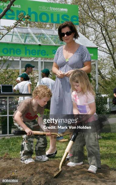Actress Marcia Gay Harden , and her children Hudson Harden Scheel , and Julitta Dee Harden Scheel help plant one of the 120 trees planted to...