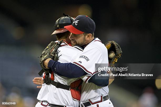 Catcher Brian McCann\ embraces pitcher John Smoltz of the Atlanta Braves following his 3000th career strikeout during the third inning against the...