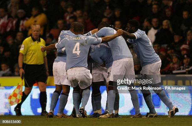 Manchester City's Micah Richards is surrounded by team-mates after scoring his sides first goal of the game