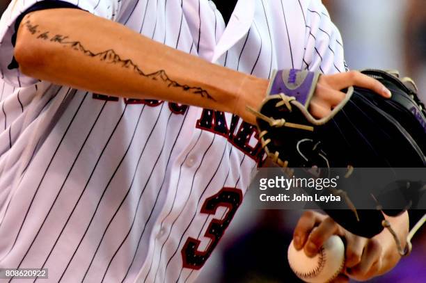 Colorado Rockies starting pitcher Kyle Freeland with his new tattoo as he delivers a pitch int he first inning against the Cincinnati Reds on July 4,...