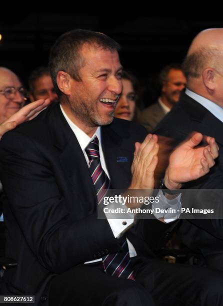 Chelsea owner Roman Abramovich reacts as Russian Prime Minister Vladimir Putin speaks at a Russia 2018 press conference at the Zurich Exhibition...