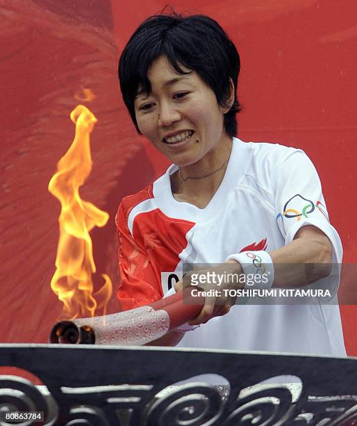 Athens Olympic women's marathon gold medalist Mizuki Noguchi lits the cauldron after finishing the Beijing Olympic torch relay at the central Nagano...