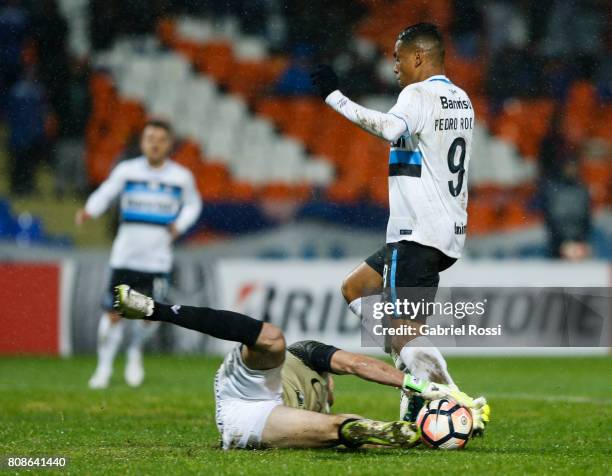 Pedro Rocha of Gremio fights for the ball with Rodrigo Rey goalkeeper of Godoy Cruz during a first leg match between Godoy Cruz and Gremio as part of...